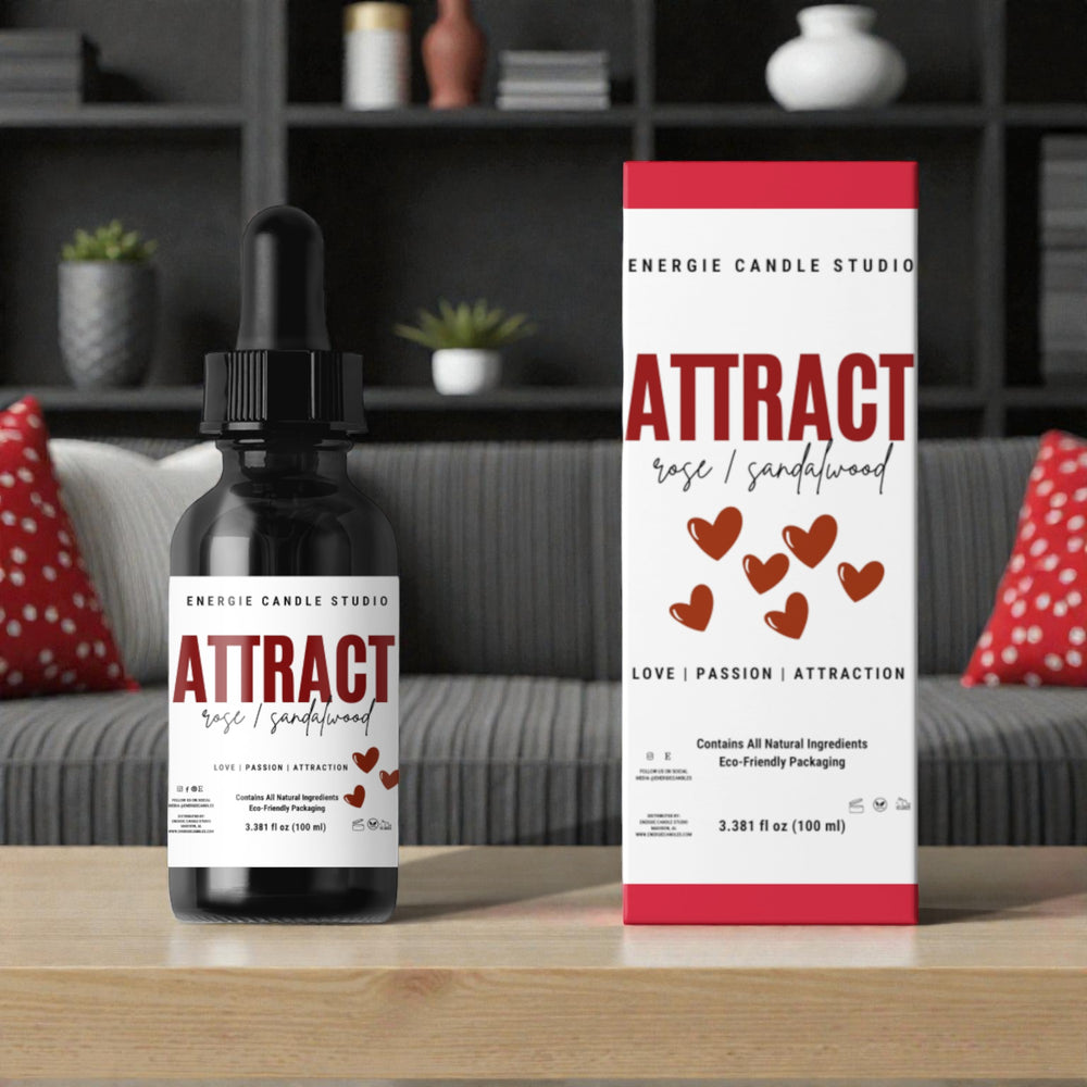 Energie Candle Studio 'Attract' product on a wooden surface with a blurred background