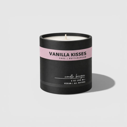 Vanilla Kisses candle with black and pink label on a light gray background