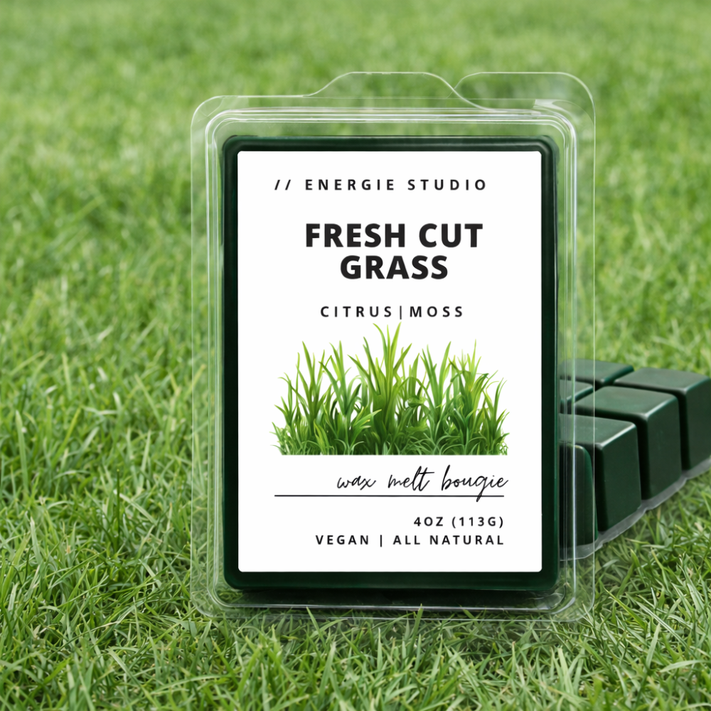 Wax melt bouquet packaging labeled 'Fresh Cut Grass' on a grass background