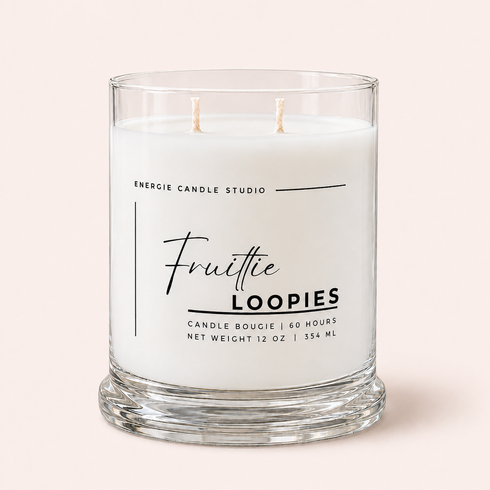 A two-wick scented candle in a clear glass jar with a thick base, featuring a white label that reads 'Energie Candle Studio' and 'Fruittie LOOPIES' on a pale pink background.