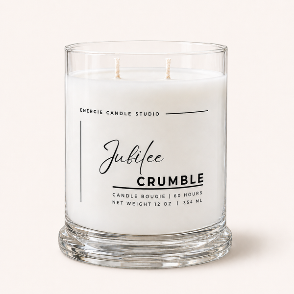 A two-wick glass jar candle with white wax by Energie Candle Studio, labeled 'Jubilee CRUMBLE', set against a solid off-white background.