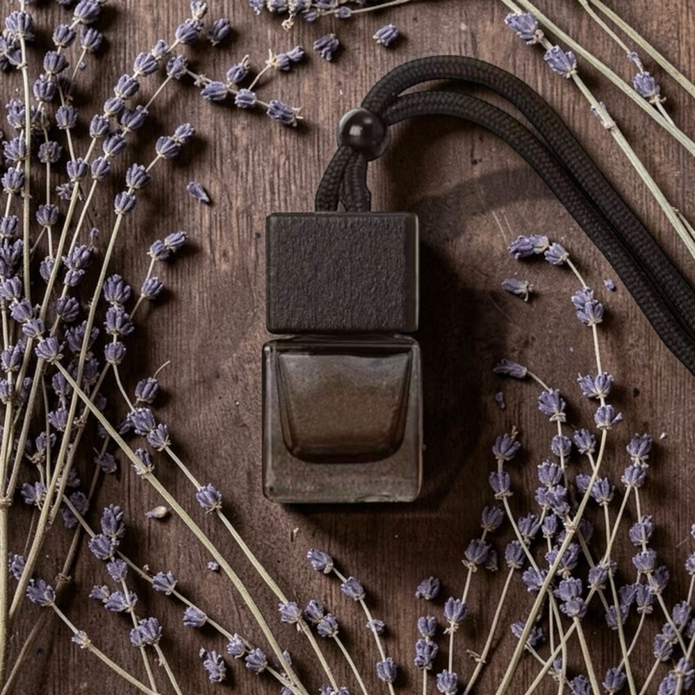 Bronze-colored air freshener on a wooden surface with lavender sprigs