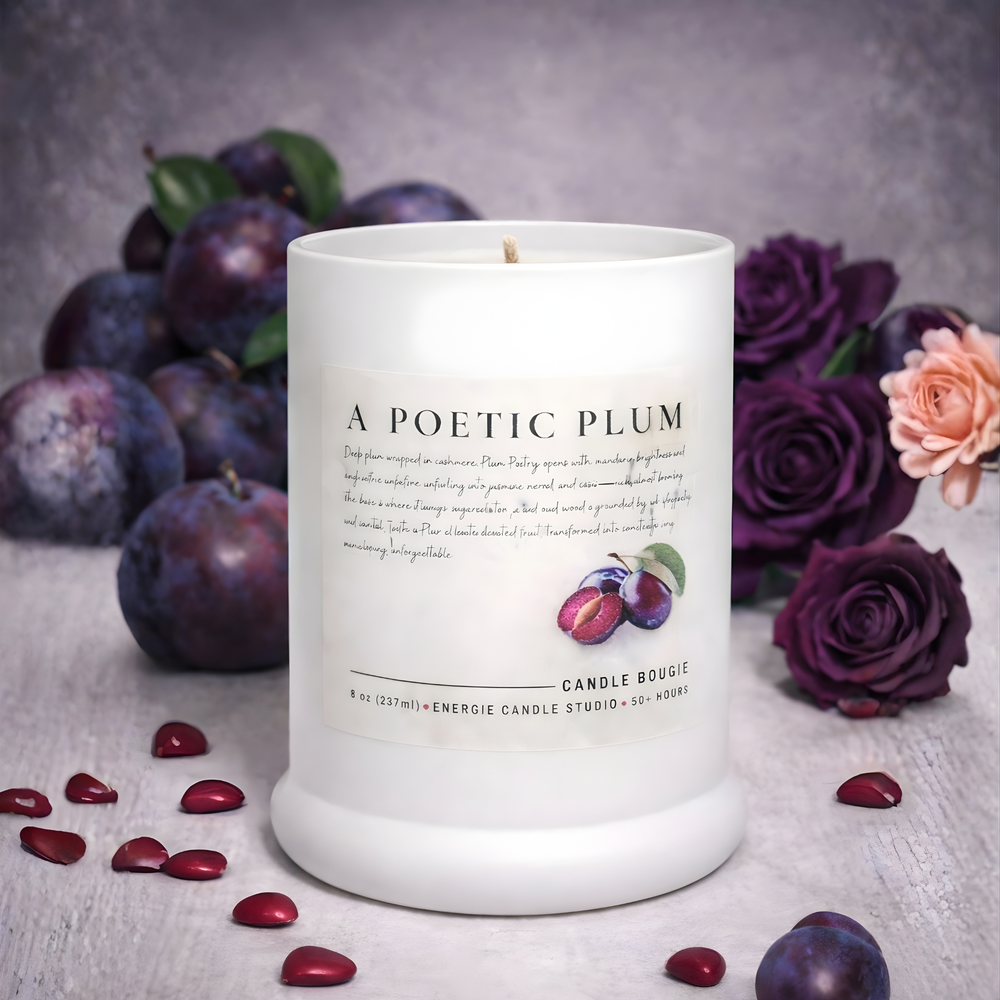 Candle with plum and rose elements on a textured surface