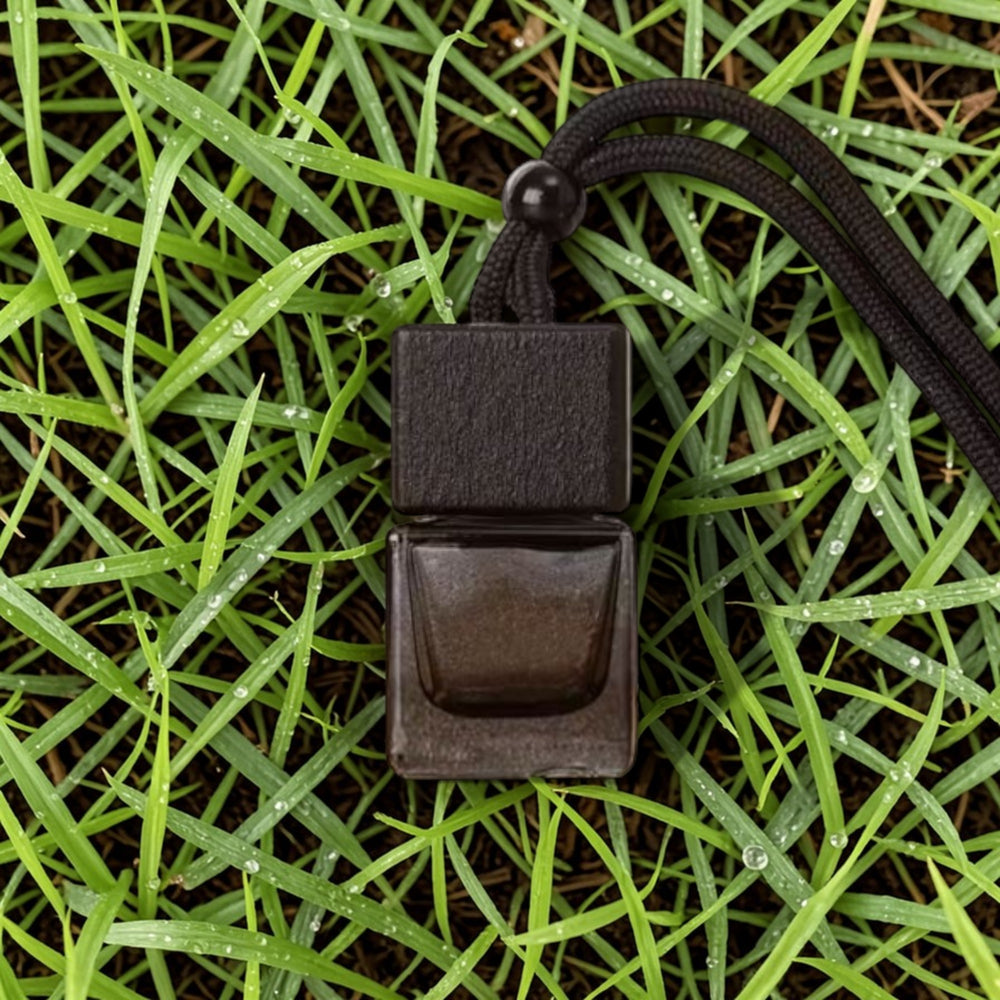 Black leather belt buckle on grass