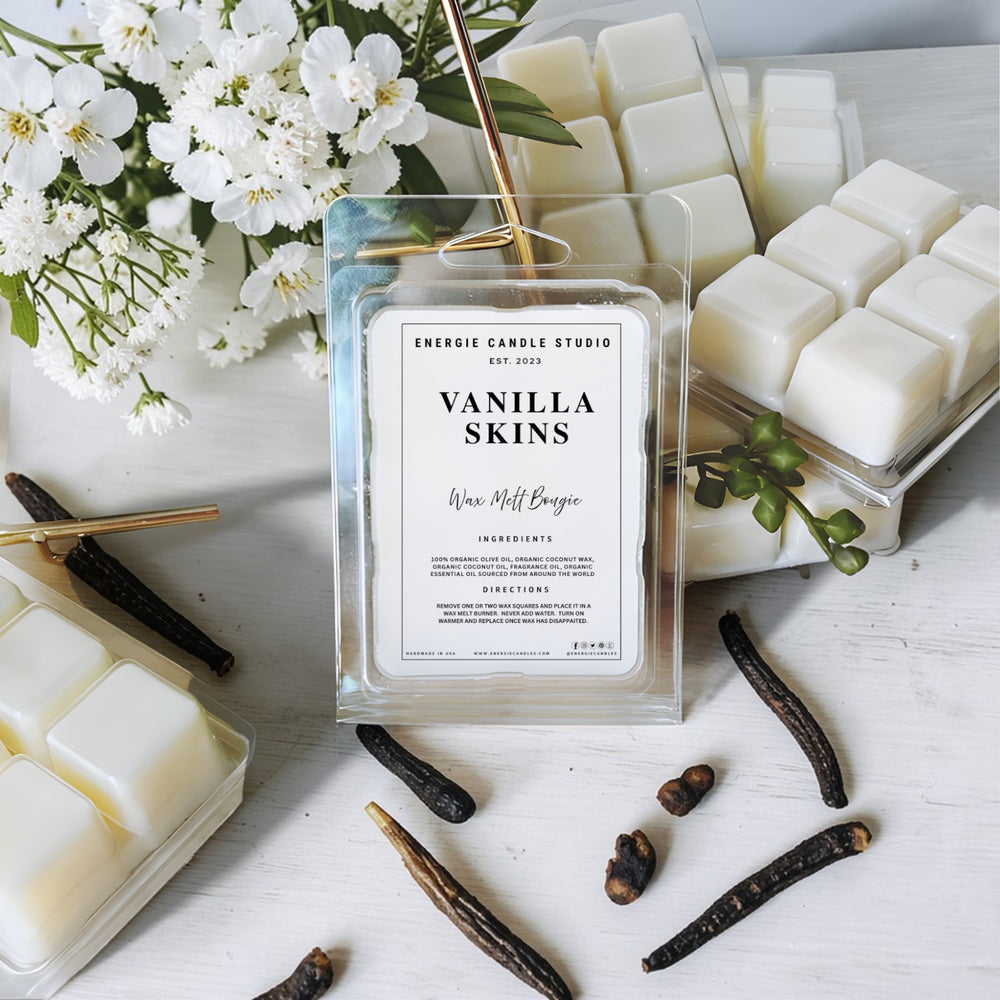 Vanilla skins wax melt bag with flowers and vanilla beans on a white surface