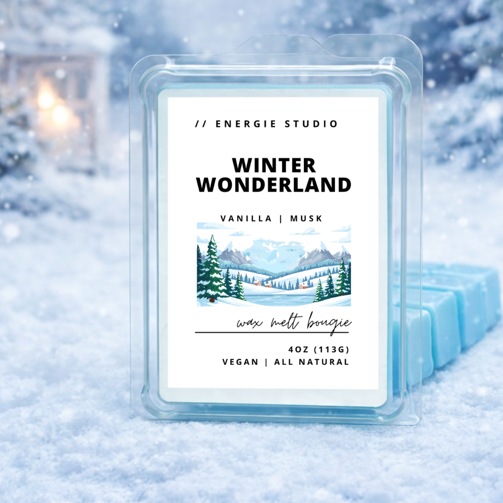 Wax melt bougie labeled 'Winter Wonderland' by Energie Studio in a snowy setting.