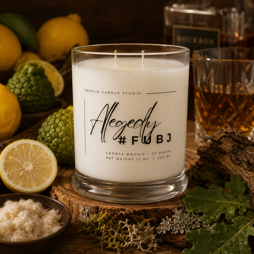 Candle with 'Allegedly #FUBJ' text on a wooden surface with lemons and other items.