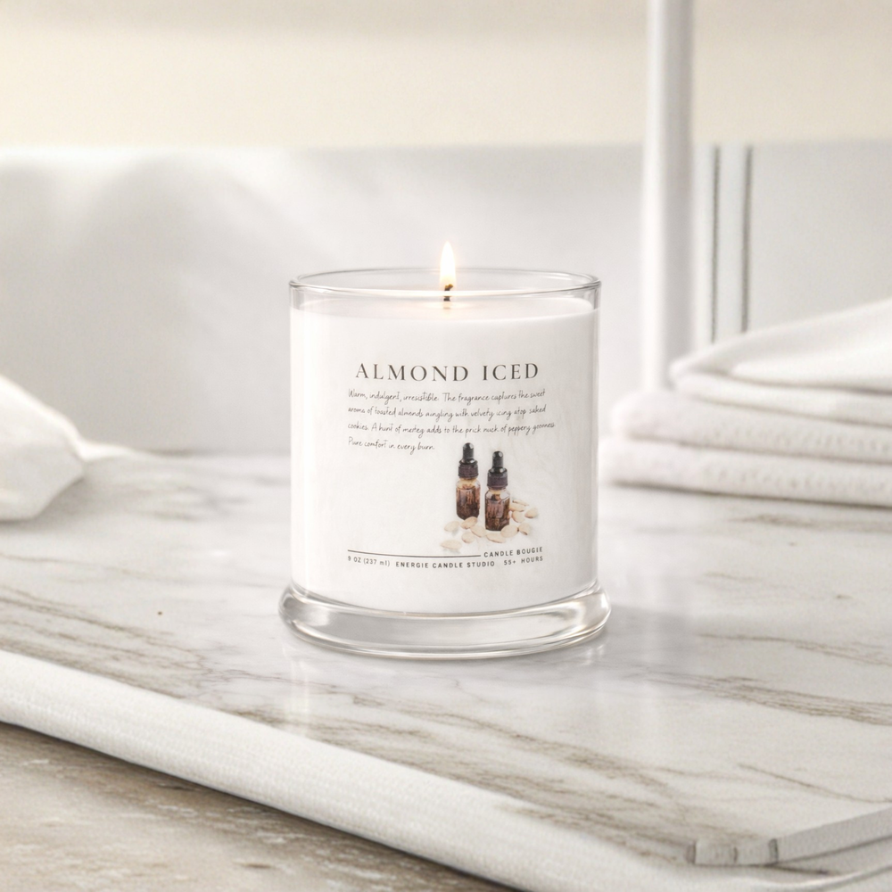 Candle labeled 'Almond Iced' on a marble surface with a neutral background