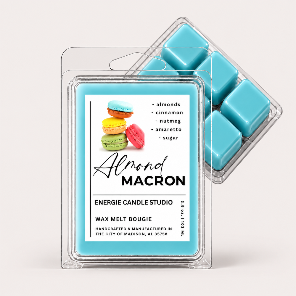 Two clear plastic wax melt clamshells on a light warm gray background. The front pack shows a white label with the scent name Almond Macron, a macaron graphic, and a bright aqua wax melt color.
