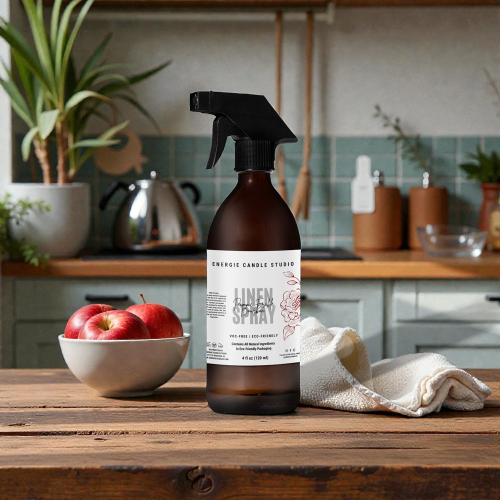 Linen spray bottle on a wooden table with apples and a bowl in a kitchen setting