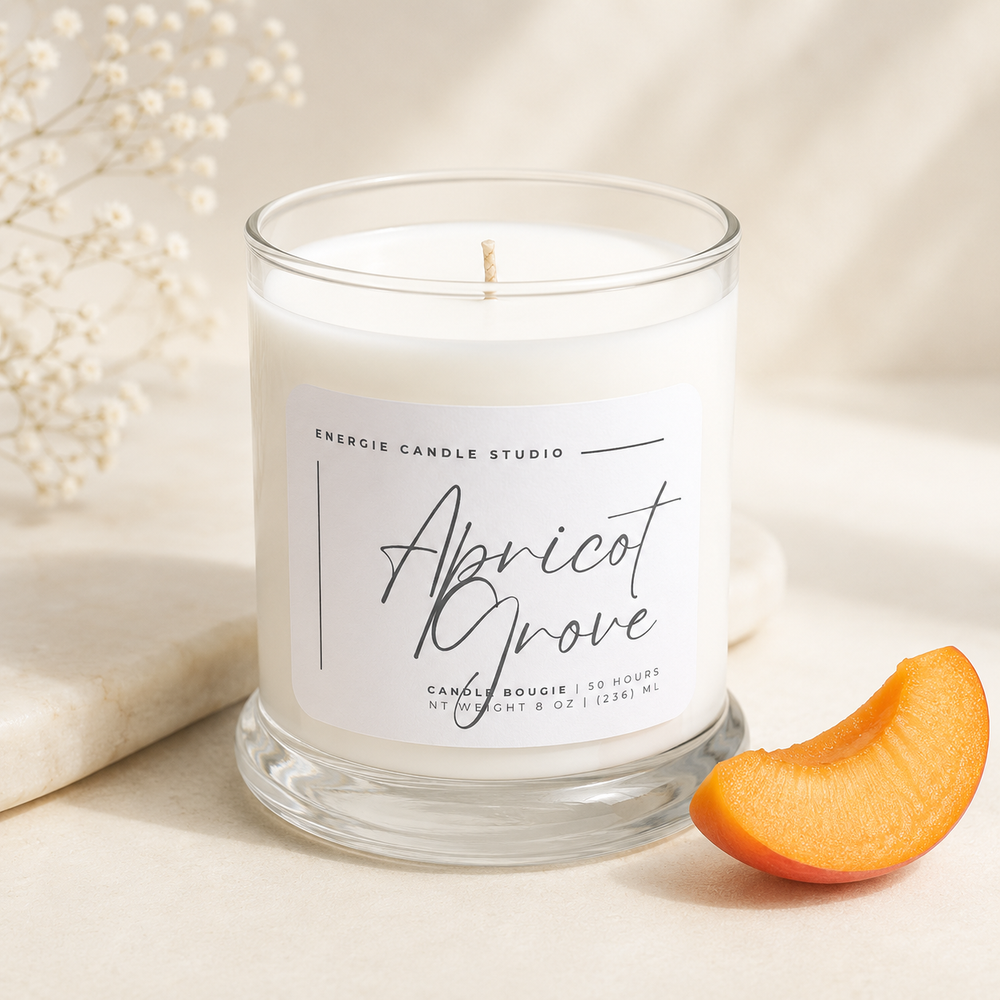 Candle labeled 'Apricot Grove' from Energie Candle Studio with a slice of apricot on a neutral background.