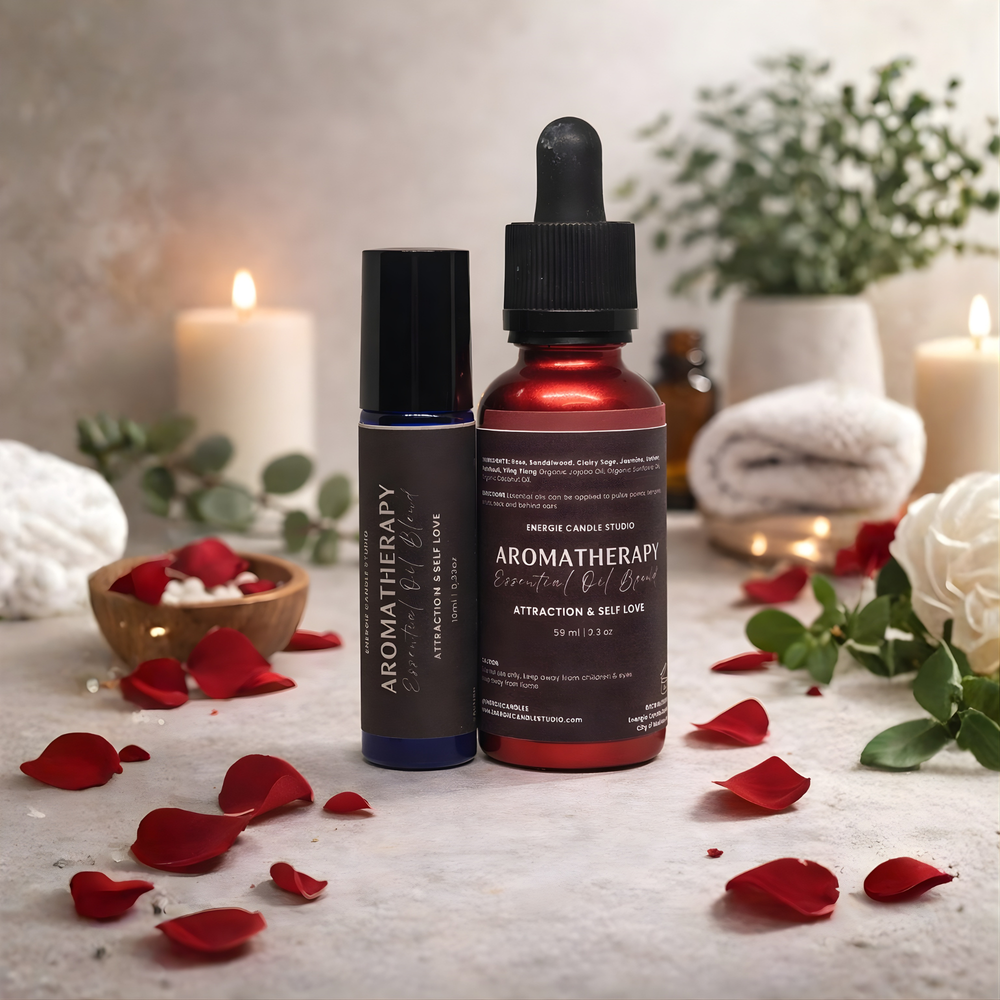 Two aromatherapy essential oil bottles on a table with candles and flowers in the background.