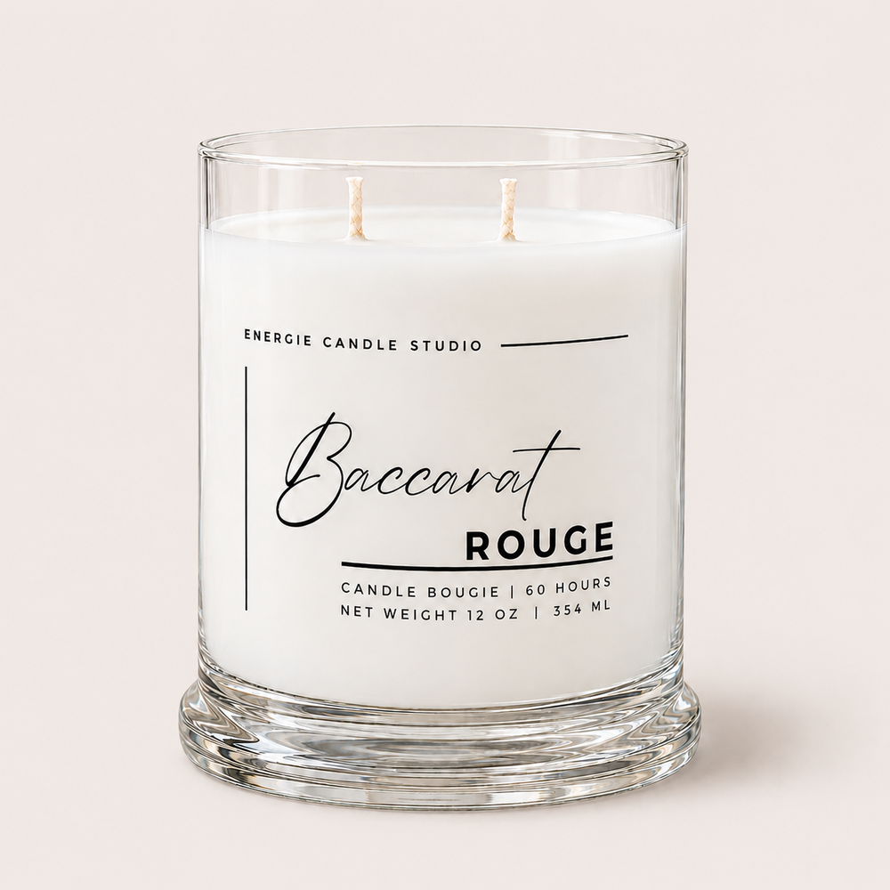 A two-wick scented candle in a clear glass jar with a thick base, featuring a white wax label that reads 'Baccarat ROUGE' and 'ENERGIE CANDLE STUDIO' on a light beige background.