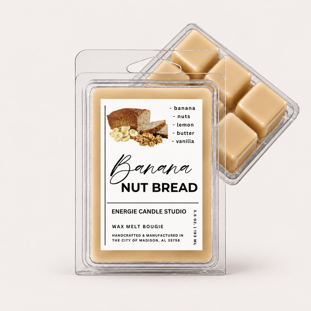 Two clear plastic wax melt clamshells on a light warm gray background. The front package is labeled 'Banana NUT BREAD' by Energie Candle Studio, showing a beige wax melt and scent notes including banana, nuts, lemon, butter, and vanilla.