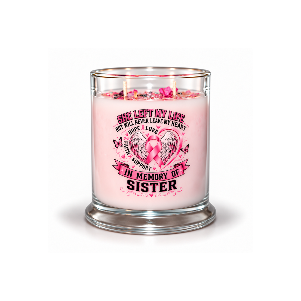 A pink scented candle in a clear glass jar with a thick glass base, featuring a printed memorial design on the front that reads 'She left my life but will never leave my heart.