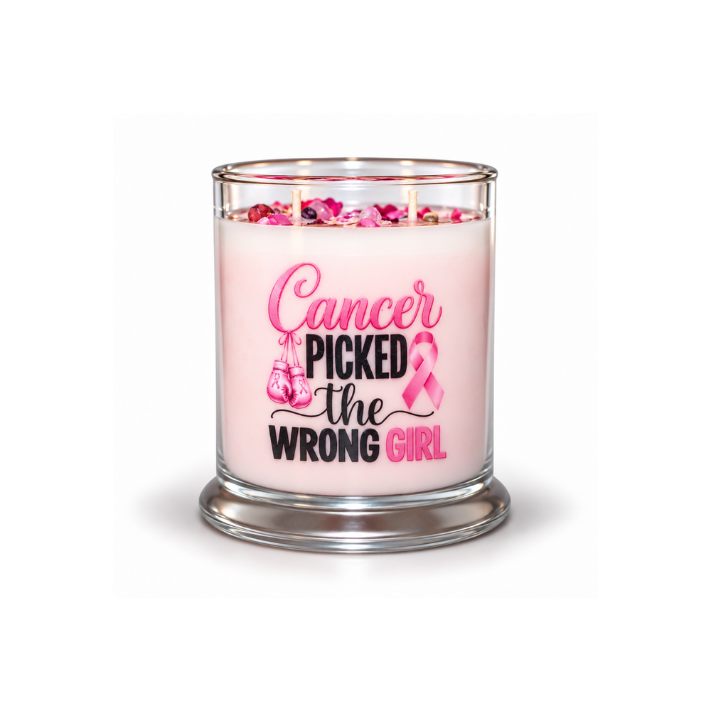 A pink wax candle in a clear glass jar with a silver-toned base, featuring the printed message 'Cancer Picked the Wrong Girl' in pink and black lettering with a pink awareness ribbon and shoe graphic. The candle is shown on a clean white background with a soft shadow.