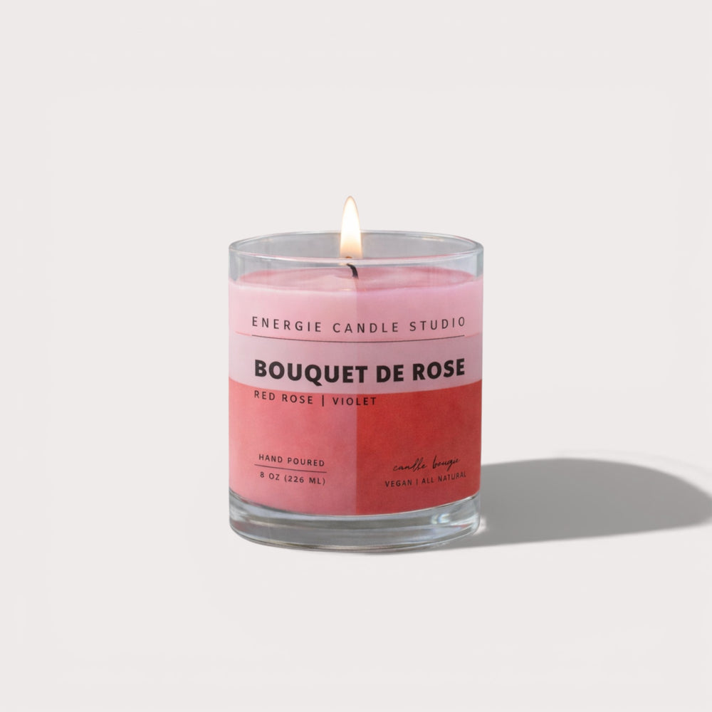 Pink candle with a label on a white background