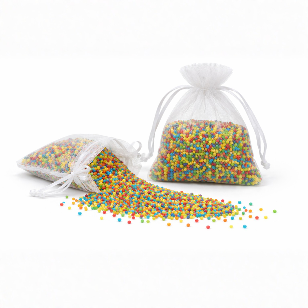Two white drawstring bags filled with colorful beads on a white background