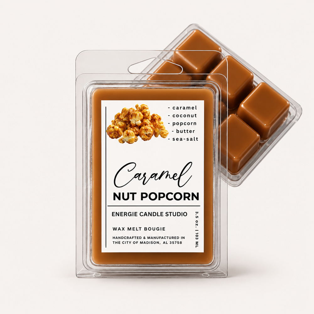 Two clear plastic wax melt clamshells on a light warm-gray background. The front package shows a caramel nut popcorn scent label with a photo of popcorn and the text 'Caramel Nut Popcorn' and 'Energie Candle Studio.