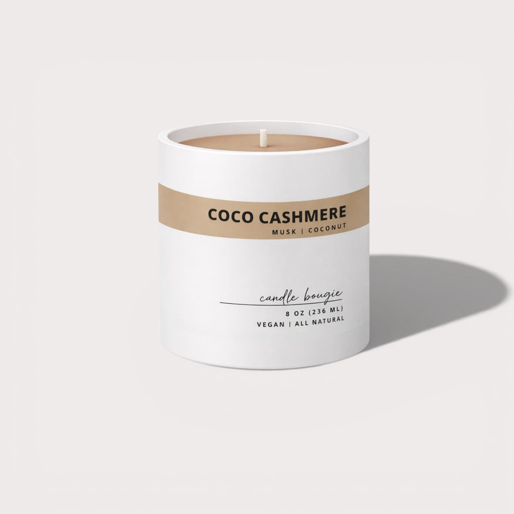Candle labeled 'Coco Cashmere' with a white and brown label on a light gray background