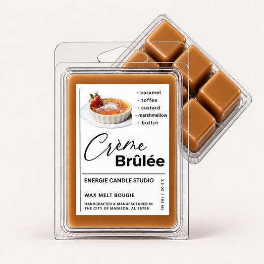 Two clear plastic clamshell packages of wax melt are shown on a clean white background. The front package is labeled 'Crème Brûlée' by Energie Candle Studio, and the rear package shows six caramel-colored wax cubes.