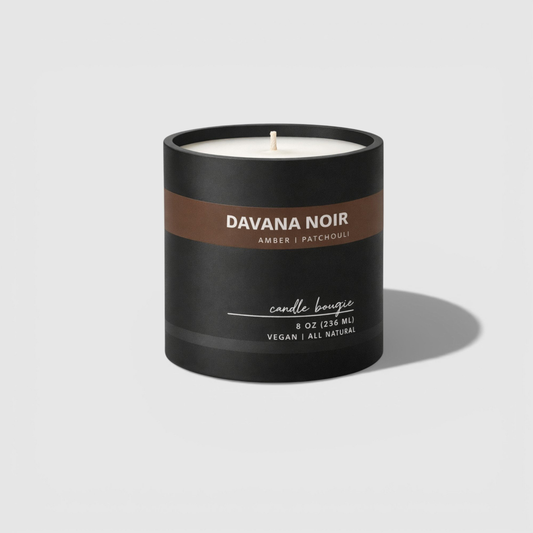 Davana Noir candle with black and brown label on a light gray background