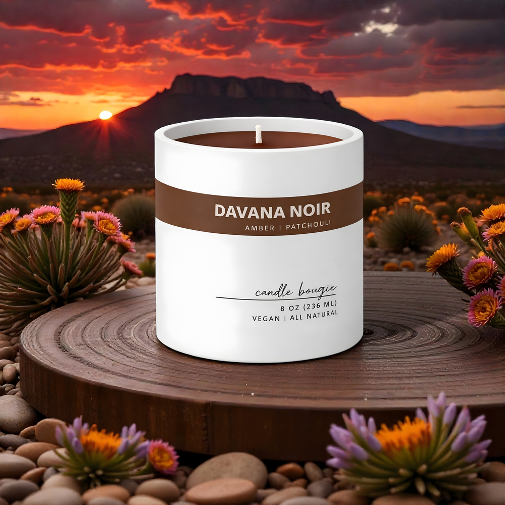 Candle with 'Davana Noir' branding against a desert sunset backdrop