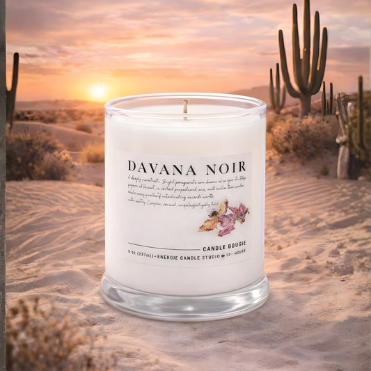 DAVANA NOIR candle in a desert setting with cacti and a sunset.