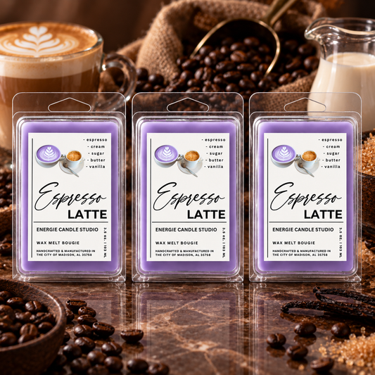 Three wax melt packages labeled 'Espresso Latte' arranged on a reflective surface with coffee beans, a cup of latte, burlap, and a glass jar in a warm coffee-themed setting.