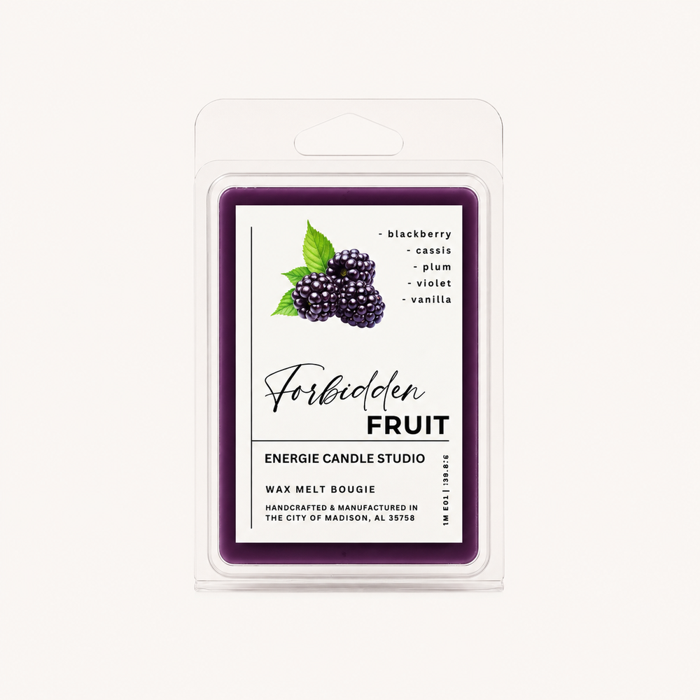 A packaged wax melt in a clear plastic clamshell package with a white label. The label has a dark purple border and reads 'Forbidden Fruit' with a blackberry illustration and scent notes including blackberry, cassis, plum, violet, and vanilla.