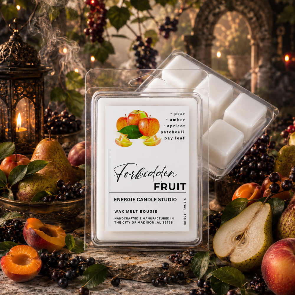 A packaged wax melt product labeled 'Forbidden Fruit' by Energie Candle Studio, shown in a clear plastic clamshell with white wax cubes visible, surrounded by fruit and berries in a styled rustic scene.