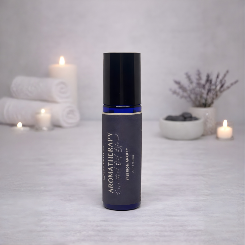 Aromatherapy essential oil bottle with candles and towels in the background