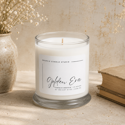 Candle with 'Golden Era' label on a surface with decorative elements