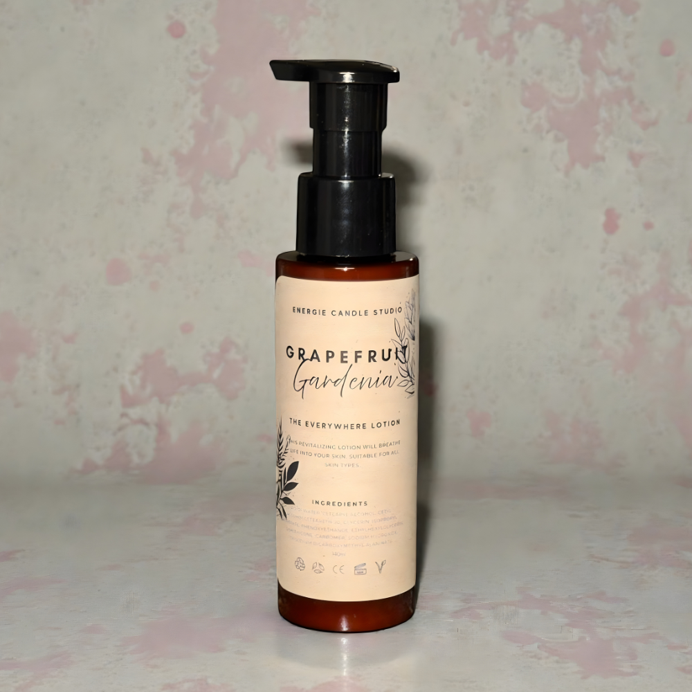 Bottle of Grapefruit Gardenia lotion with a floral patterned background