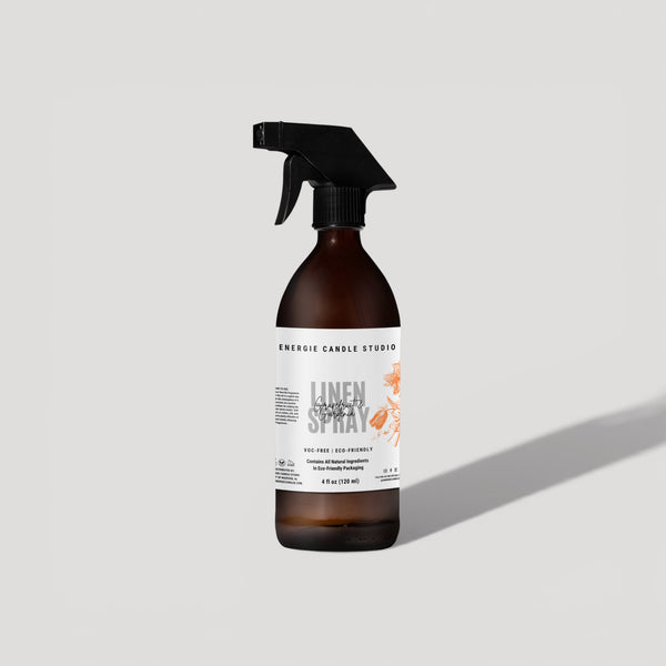 Brown spray bottle with a label on a light gray background