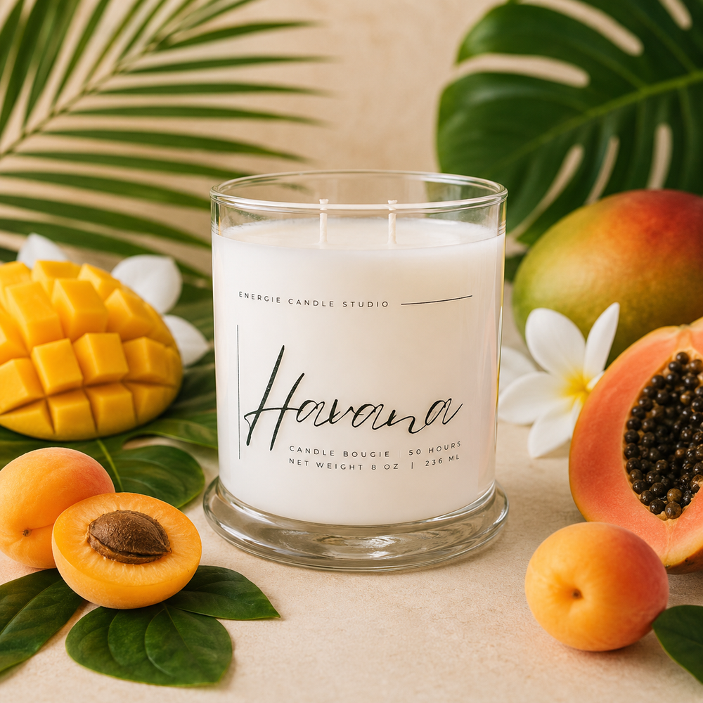 Candle labeled 'Havana' surrounded by tropical fruits and leaves on a beige background