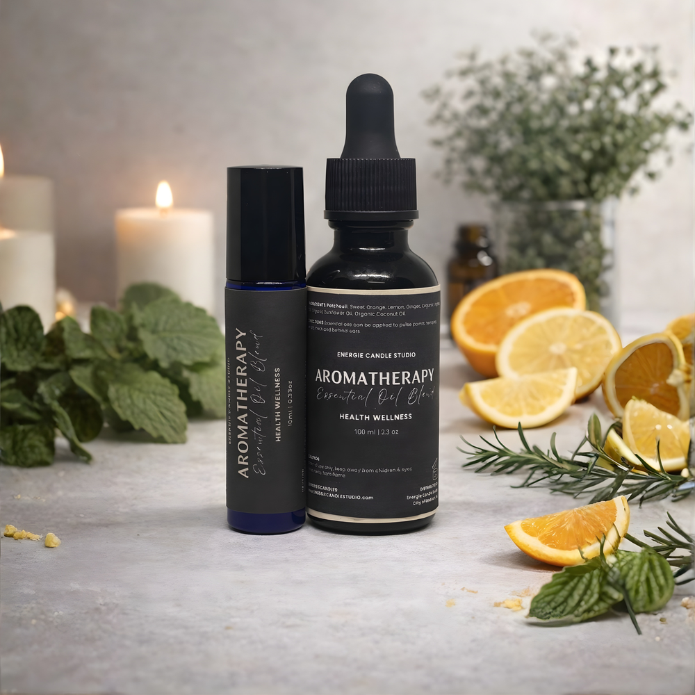 Aromatherapy essential oil bottles with oranges and candles on a table