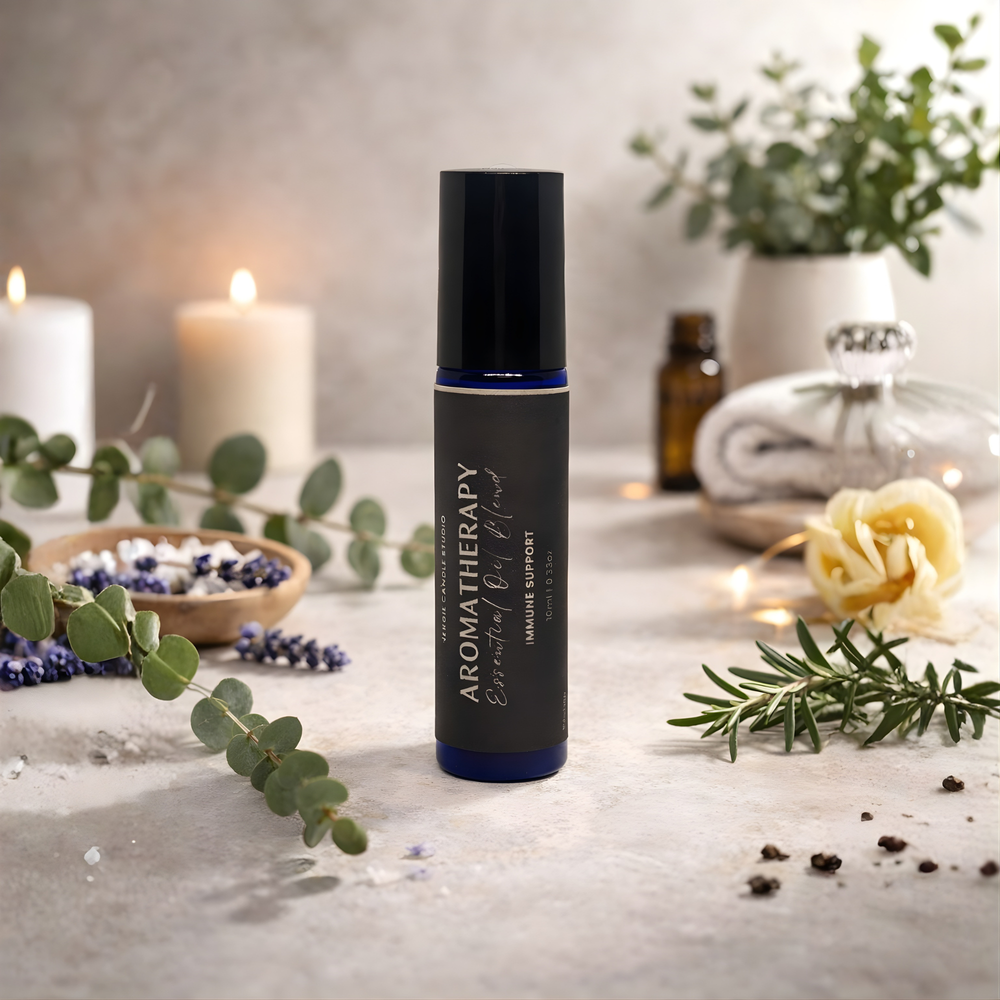 Aromatherapy essential oil roller bottle on a table with candles and plants
