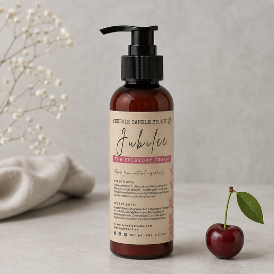 Bottle of 'Jubilee'Everyday Cream from Everlee Candle Studio on a neutral background with a cherry and dried flowers.