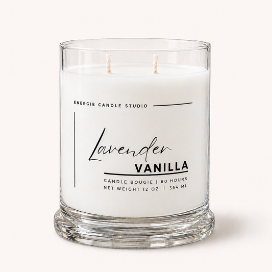 A two-wick candle in a clear glass jar with white wax, labeled 'Lavender Vanilla' by Energie Candle Studio, on a light cream background.