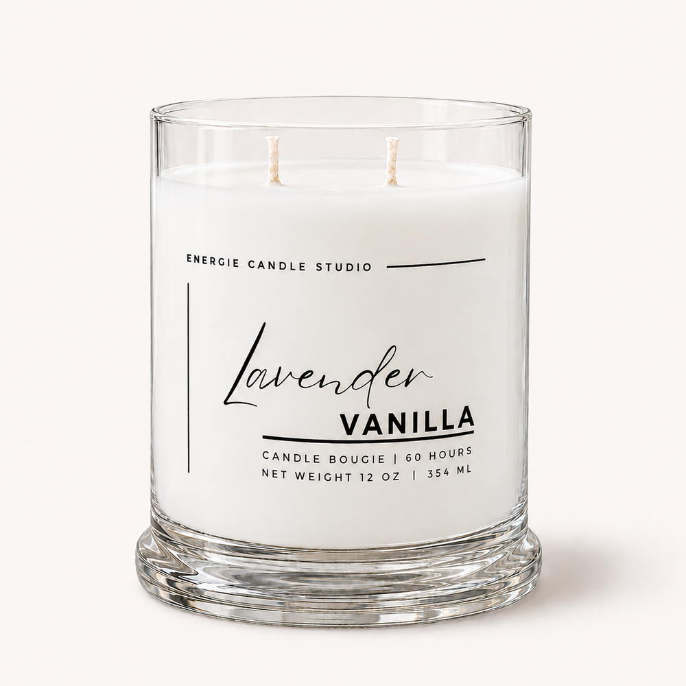 A two-wick candle in a clear glass jar with white wax, labeled 'Lavender Vanilla' by Energie Candle Studio, on a light cream background.