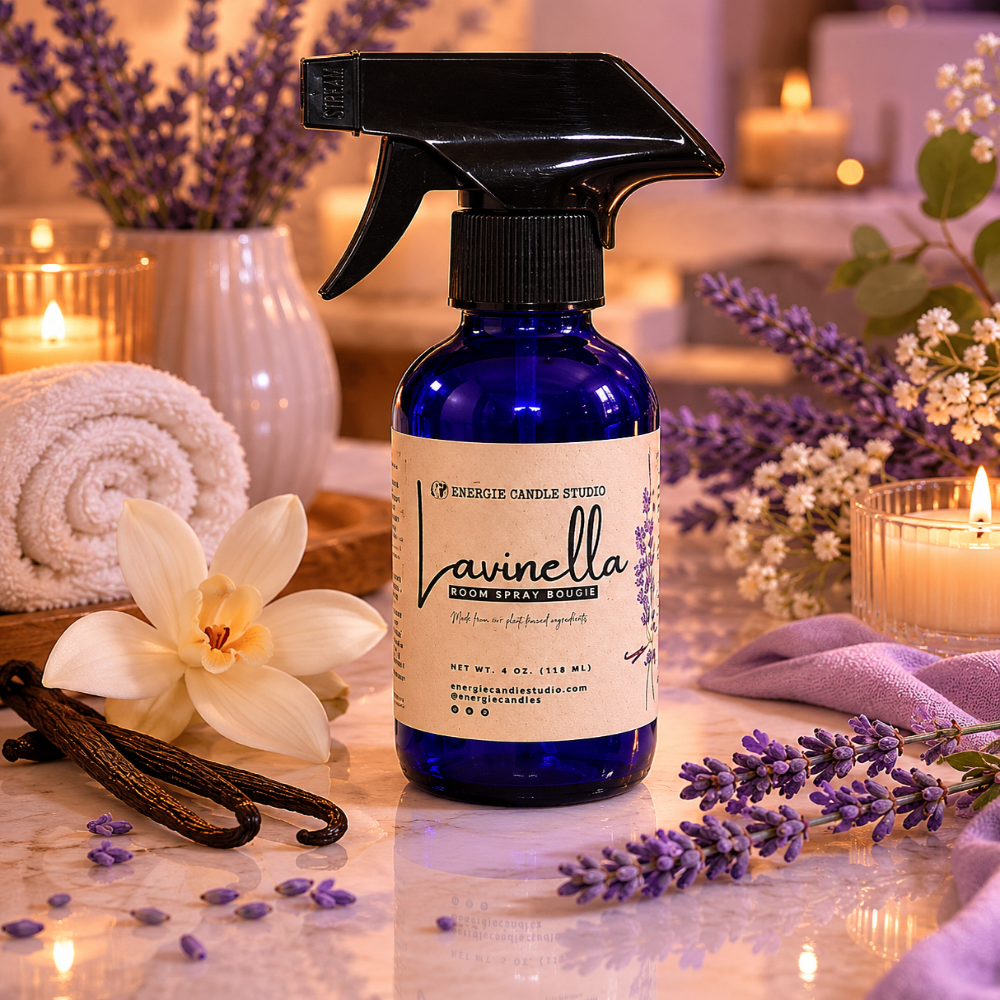 Blue spray bottle labeled 'Lavinella' surrounded by lavender flowers and candles on a wooden surface.