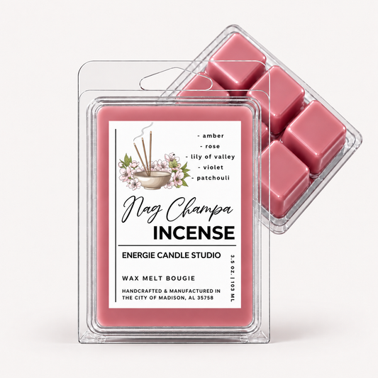 A clear plastic clamshell package of Mag Champa Incense wax melt with a white label, shown in front of a second package containing six pink wax cubes. The label reads 'Mag Champa INCENSE' and 'ENERGIE CANDLE STUDIO'.