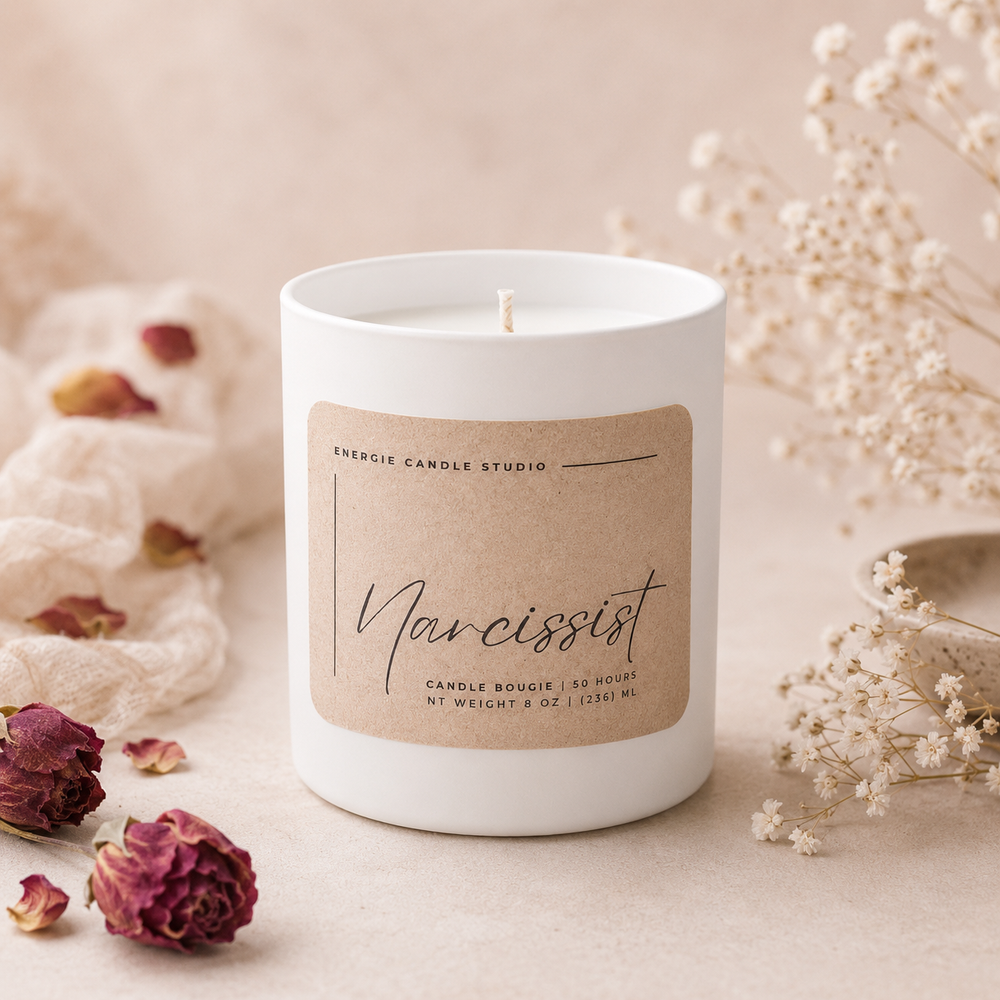 candle with beige label and babys breath on beige background with dried flowers