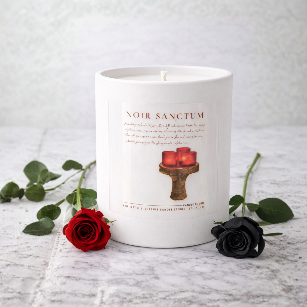 White candle with 'Noir Sanctum' branding and design, surrounded by red and black roses on a light gray background.
