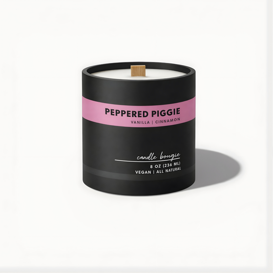 Candle with a black container and pink label on a white background