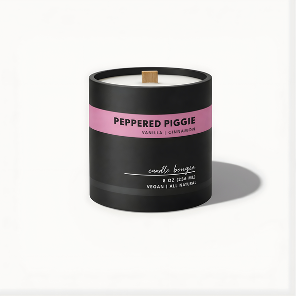 Candle with a black container and pink label on a white background