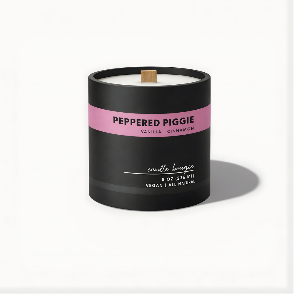 Candle with a black container and pink label on a white background