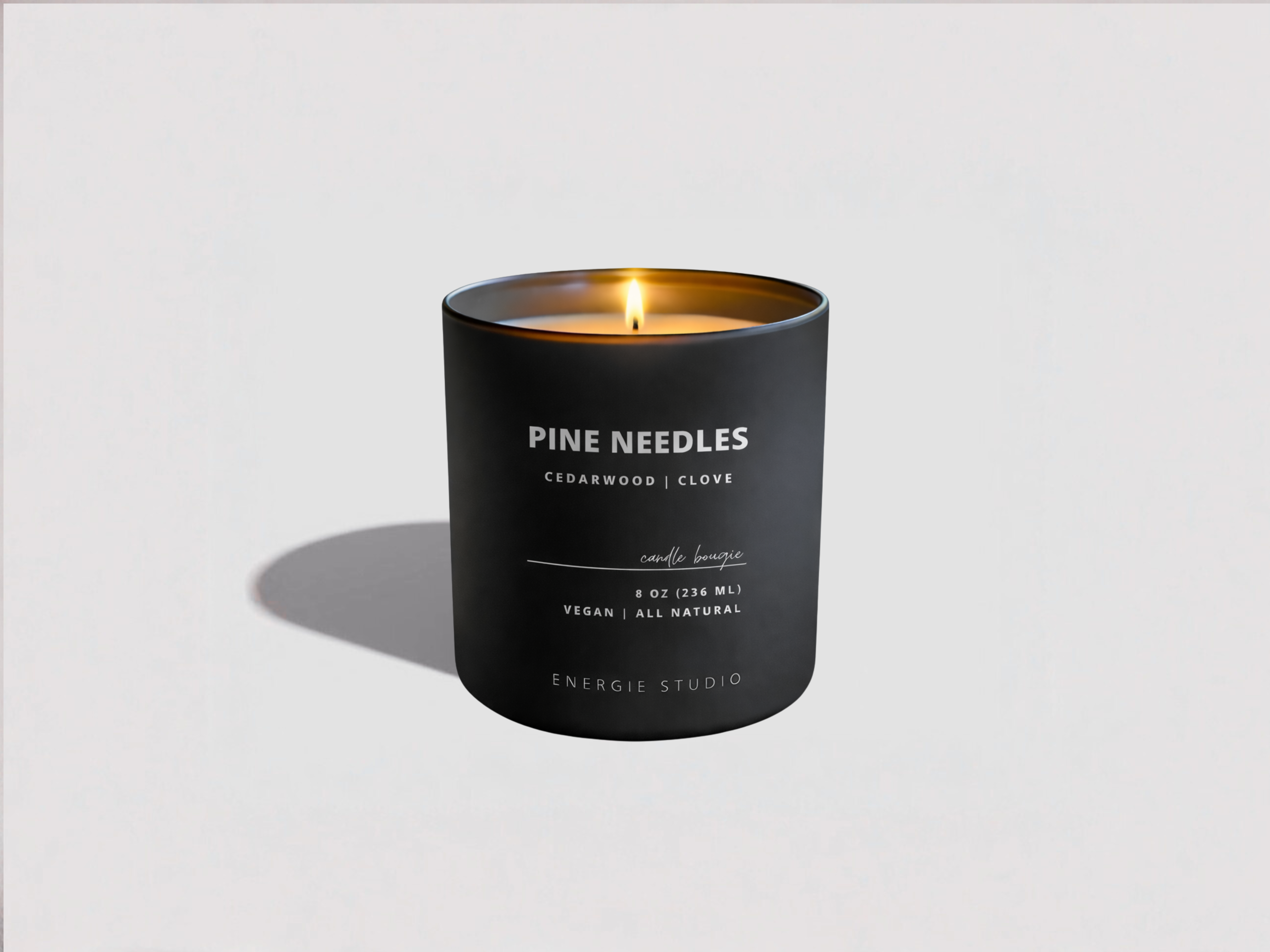 Black candle labeled 'Pine Needles' on a white background