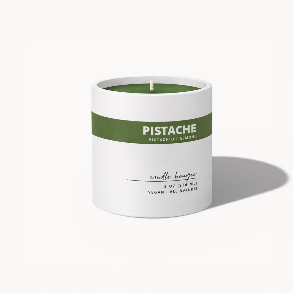 Candle with 'Pistache' label on a white background